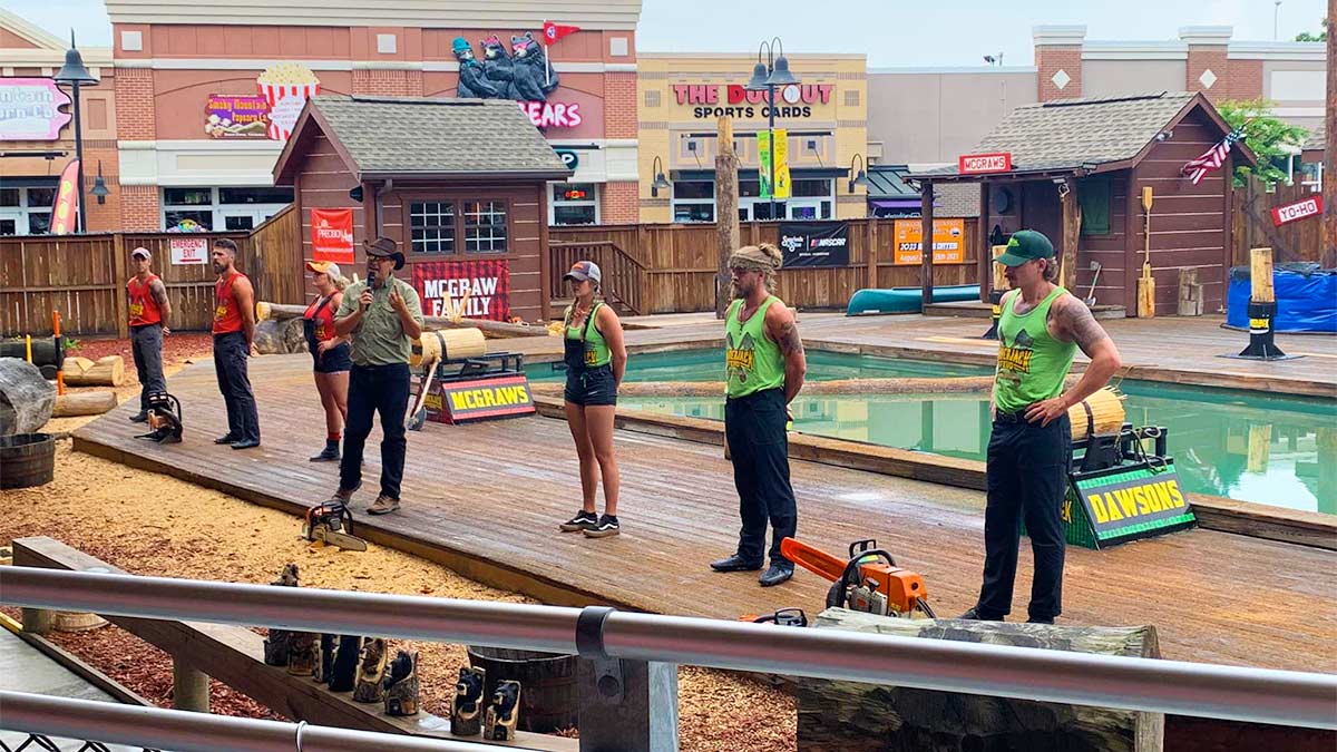 lumberjacks standing in front of crowd near a pool at Paula Deen's Lumberjack Feud Show in Pigeon Forge, Tennessee, USA